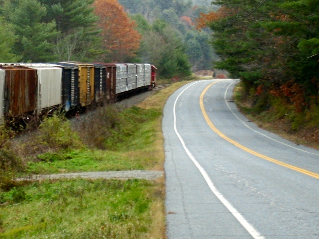 Freight train and empty road converge